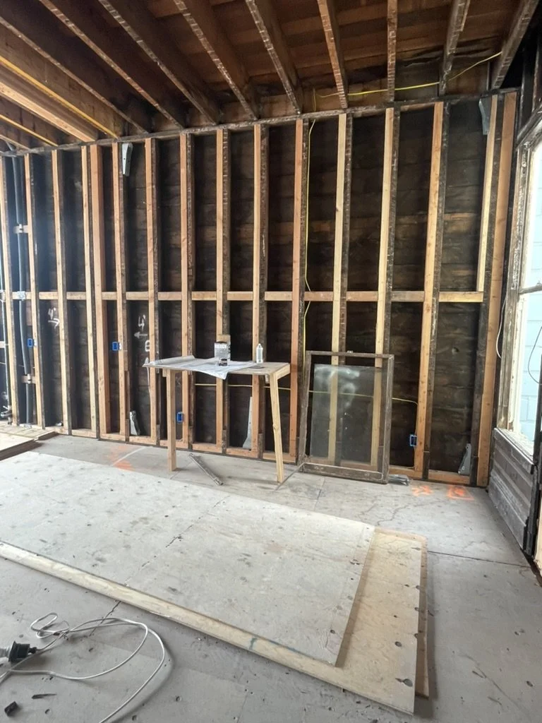 The kitchen space before renovation, framed to the studs